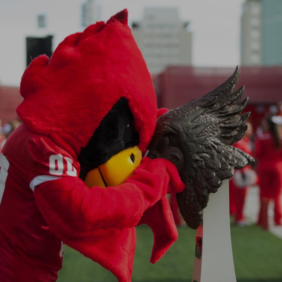 Reggie mascot with the Battle Bird statue.