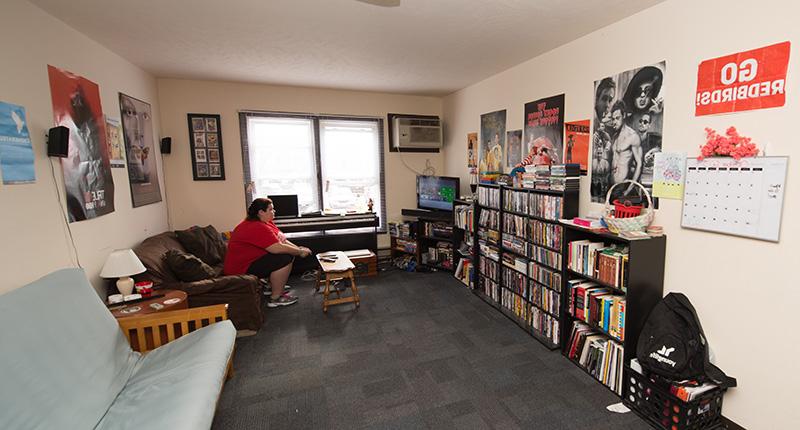 Student playing video games in the living room of their apartment.