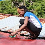 Student scrubbing a roof on a service trip.